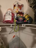 Shelf view showing boxed Minion Stuart figure, Minion plush, toy phone, and packaged Carol Channing doll