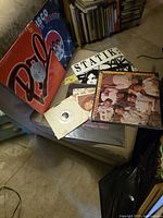 Group of LPs and 7-inch on chair showing front covers and sleeves