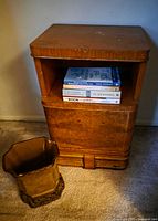 Nightstand with planter and books for scale