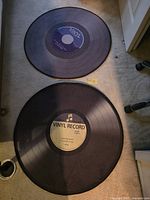 Two round record-style rugs on floor