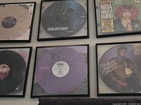 Overview showing six framed vinyl records on wall