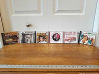 Six CD jewel cases lined up on table