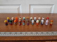 Lineup of 22 Mighty Beanz on ruler for scale