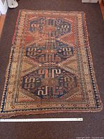 Full view of rug showing overall design and wear