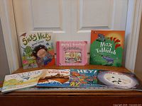 Group shot of all seven children's books on wooden surface