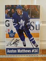 Full view of photo print showing Auston Matthews skating and facsimile signature