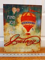 Front view of Dawna Barton tin sign with hot air balloons and text