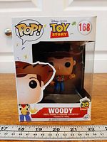 Front view of boxed Funko Pop Woody #168 figure