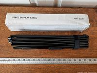 Box labeled Steel Display Easel with folded easel and ruler for scale