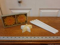 Boxed sunflower candles, star candle, five taper candles with ruler for scale