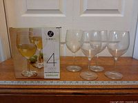 Box and four wine glasses lined in front