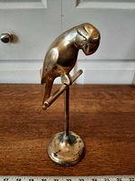 Front view of brass parrot on perch