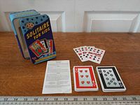 Overall view of tin, cards, and instructions