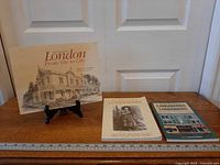 All three books laid out on wooden surface