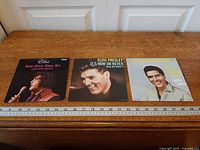 Three Elvis Presley 7-inch singles with ruler for scale