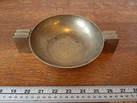 Top view showing entire brass ashtray and ruler for scale