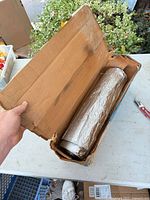 Full view of aluminum roll in cardboard box
