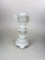 Front view of white Hirado reticulated porcelain censer on pedestal base