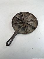 Top view of round cast-iron skillet showing eight wedge divisions