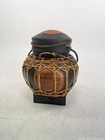 Front view of wooden jar with rattan lattice and lid