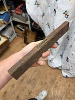 Full view of wooden level held in hand