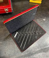 Open case showing micrometer head, rods and foam interior