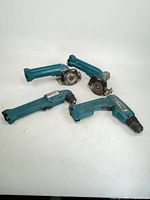 Four Makita teal cordless power tools, two circular saws, two drills/drivers