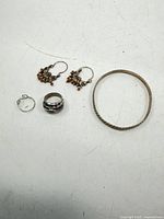 Group shot showing both rings, bangle and earrings