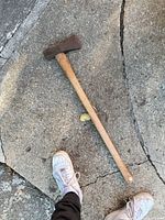 Full view of axe on concrete surface