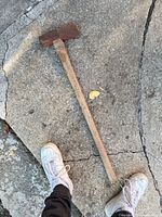 Full view of splitting maul on pavement