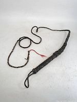 Full view of braided leather bull whip with loop handle and frayed fall