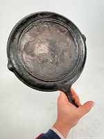Underside of skillet showing gate mark and overall surface