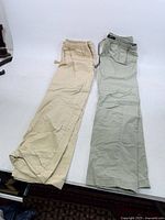 Two pairs of pants laid flat showing full length and colors