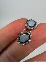 Front view of both opal doublet earrings showing scalloped sterling settings