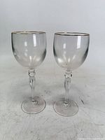 Front view of both Waterford crystal wine glasses showing overall form and gold rims