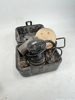 Sander, case, disc and dust bag in open case