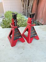 Two red Powerbuilt 4-ton jack stands front view
