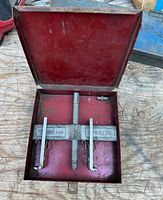 Wheel puller in open red metal box showing full assembly