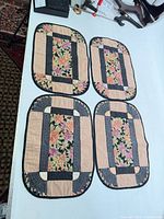 Four quilted placemats laid out on table
