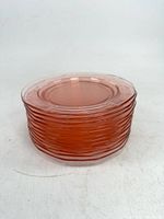 Stack of twelve pink Depression glass plates