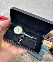 Indicator in open case showing dial and body