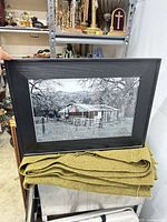 Full view of framed photograph resting on surface