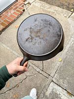 Bottom view of seasoned CHF 8A cast-iron skillet showing maker’s mark