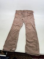 Full view of brown pants laid flat