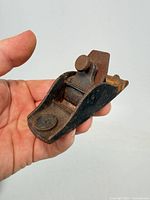 Side view of the Stanley cast iron thumb plane held in hand
