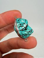 Front view of turquoise nugget showing colour, matrix and end loops