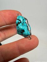 Front view of turquoise connector showing color, veining and loop findings