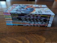 Side view showing spines of all nine Jack of Fables trade paperbacks stacked