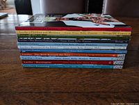 Stack of 11 Lucifer trade paperbacks showing spines with volume titles