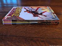 Stack of four Marvel Zombies trade paperbacks showing spines Vol 1-4
